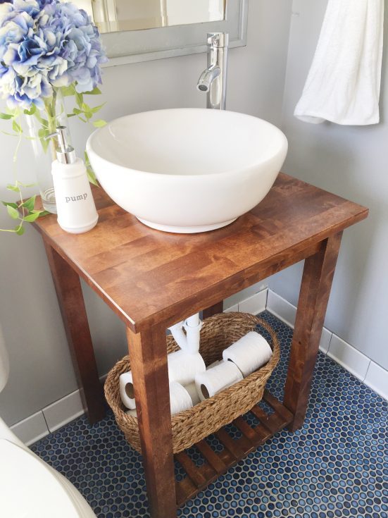 Ikea bathroom hacks - a wood kitchen stand turned into a vanity with a vessel sink on top. 
